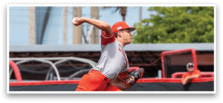 A baseball player in a red uniform is pitching a ball. AI generated content