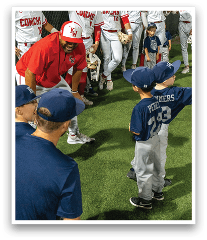 A group of young boys wearing baseball uniforms are standing on a field. AI generated content