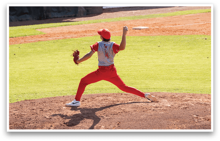 A baseball player in a red uniform is pitching a ball on a field. AI generated content