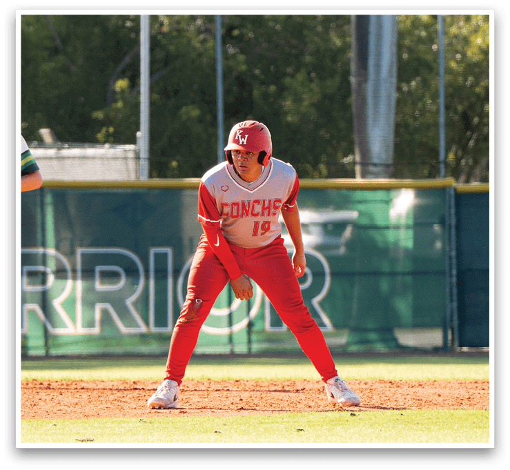 A baseball player in a red uniform is crouching on the field, ready to catch a ball. AI generated content
