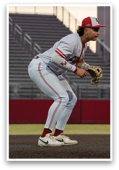 A baseball player in a white uniform is crouching on the field, holding a catcher's mitt. AI generated content