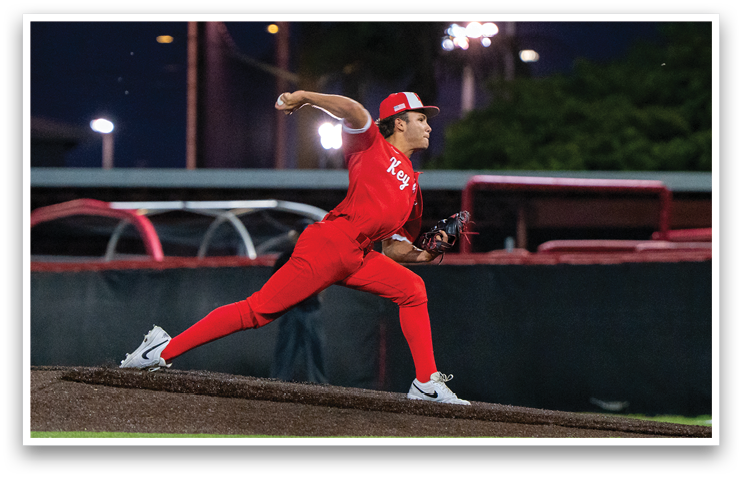 A baseball player in a red uniform is pitching a ball on a field. AI generated content