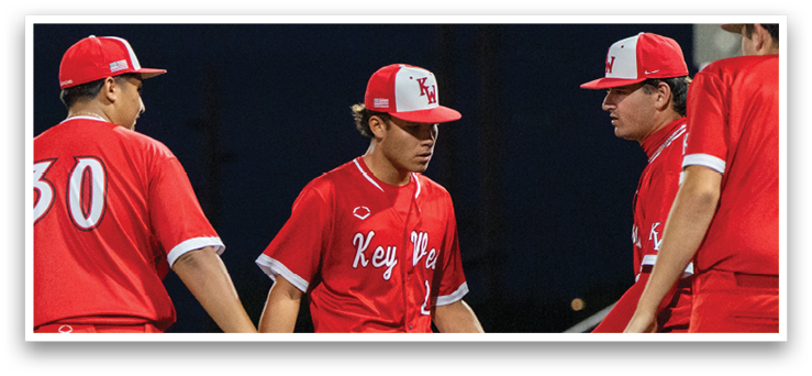 Three baseball players in red uniforms shake hands on the field. AI generated content