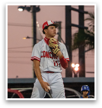 A baseball player in a red and white uniform is standing on a mound, holding a baseball in his glove. AI generated content
