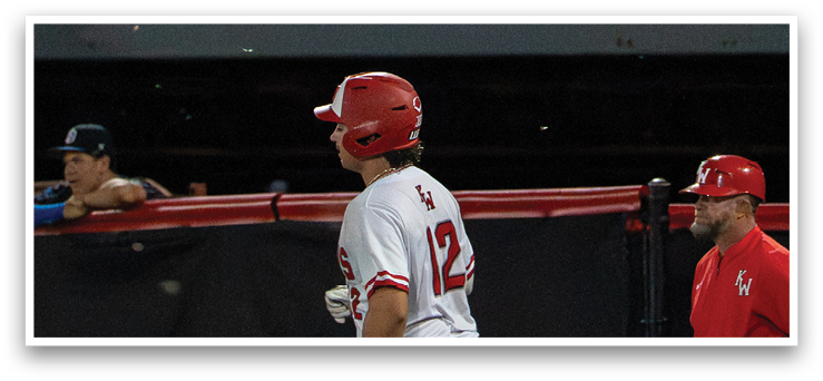 A baseball player wearing a red helmet and white uniform is running on the field. AI generated content