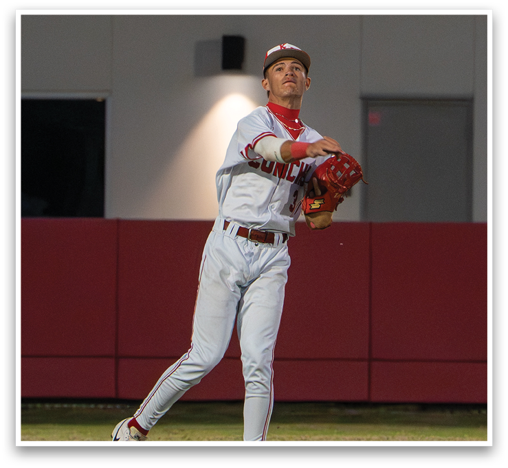 A baseball player in a white uniform is reaching up to catch a ball. AI generated content