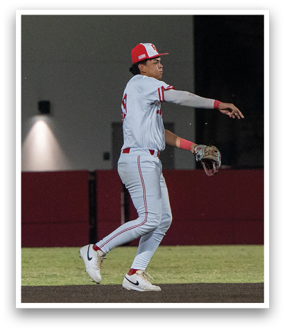 A baseball player wearing a red hat and white uniform is running on the field. AI generated content
