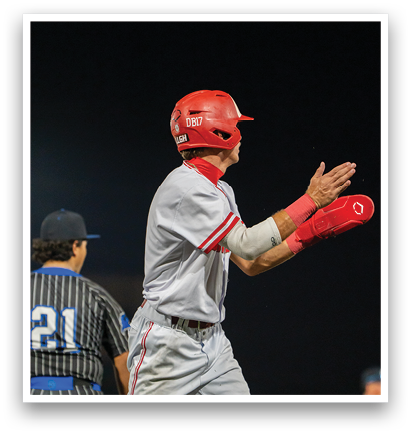 A baseball player wearing a red helmet and a white uniform is celebrating a victory. AI generated content