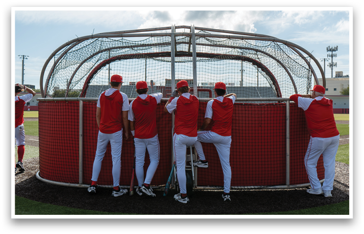 A group of baseball players leaning against a batting cage. AI generated content
