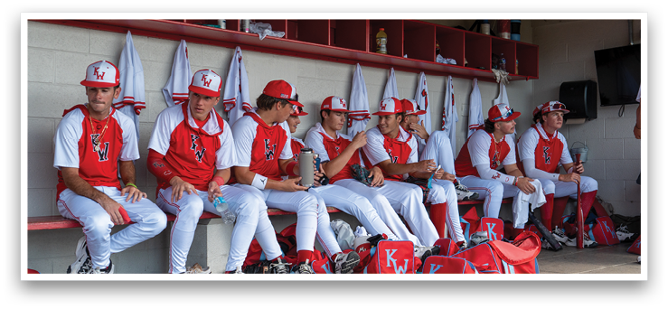 A group of baseball players are sitting on a bench, wearing their uniforms. AI generated content