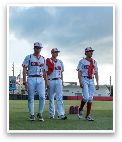 Three baseball players wearing red and white uniforms are standing on a field. AI generated content