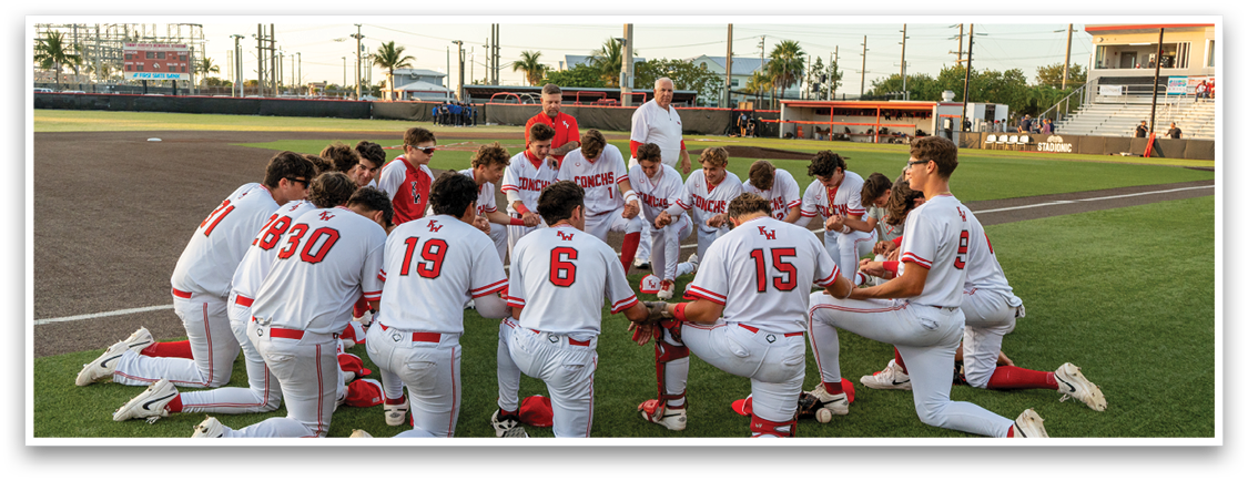 A group of baseball players kneeling on the field, praying before a game. AI generated content