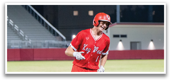 A baseball player wearing a red uniform and a helmet is running towards a base. AI generated content