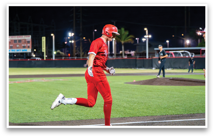 A baseball player in a red uniform is running towards home plate. AI generated content