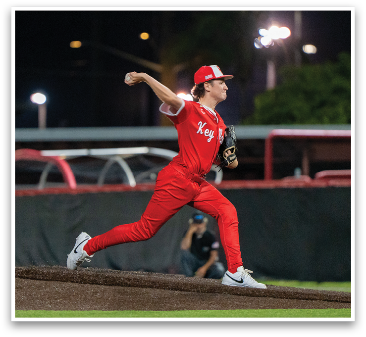 A baseball player in a red uniform is pitching a ball on a field. AI generated content