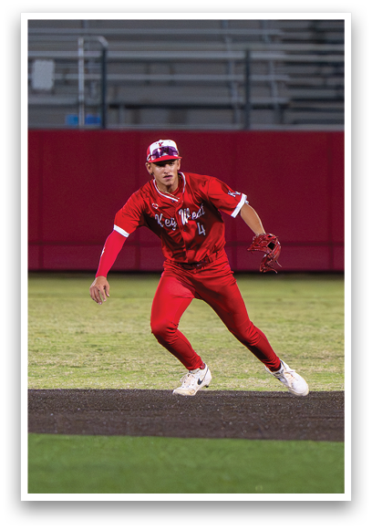 A baseball player in a red jersey is swinging a bat. Description generated by AI