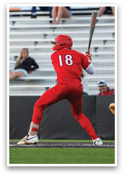 A baseball player in a red jersey is swinging a bat. Description generated by AI