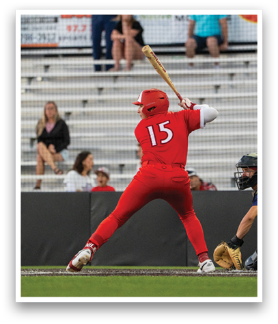 A baseball player in a red uniform is swinging a bat. Description generated by AI