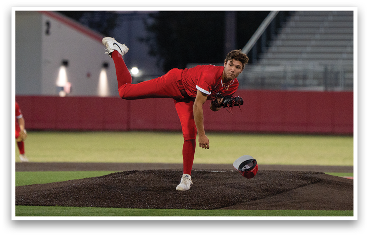 A baseball player in a red shirt and white shoes is swinging a bat. Description generated by AI