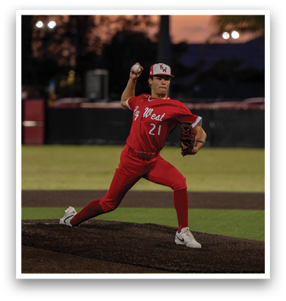 A baseball player in a red jersey and red pants is running towards home plate. Description generated by AI