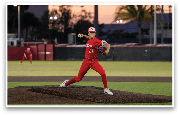A baseball player in a red shirt and white shoes is swinging a bat. Description generated by AI
