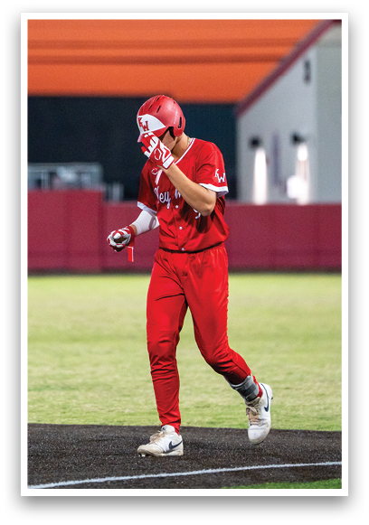 A baseball player in a red jersey is swinging a bat. Description generated by AI