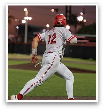 A baseball player wearing a red helmet and white uniform is running to first base. Description generated by AI