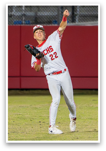 A baseball player wearing a red and white uniform is throwing a ball. Description generated by AI