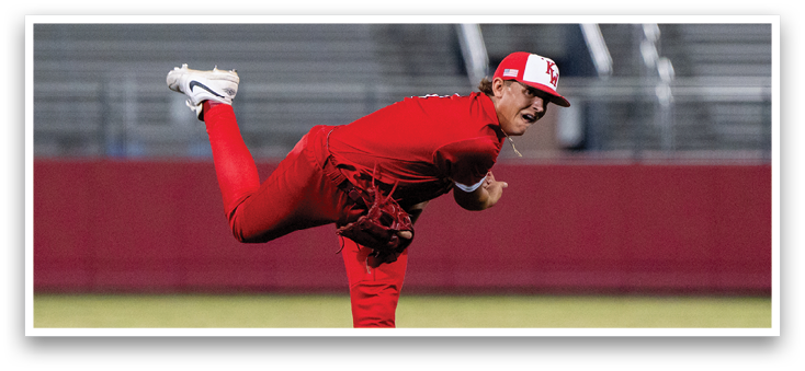 A man in a red baseball uniform is pitching a ball. Description generated by AI
