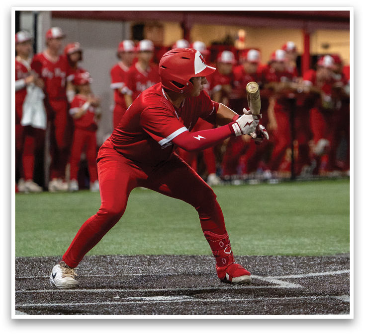 A baseball player in a red uniform is swinging a bat. Description generated by AI