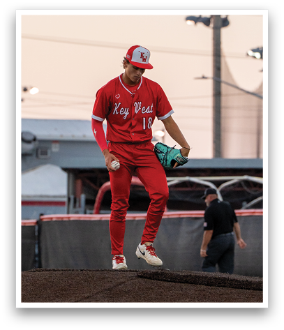 A baseball player wearing a red jersey and red pants is jumping in the air. Description generated by AI