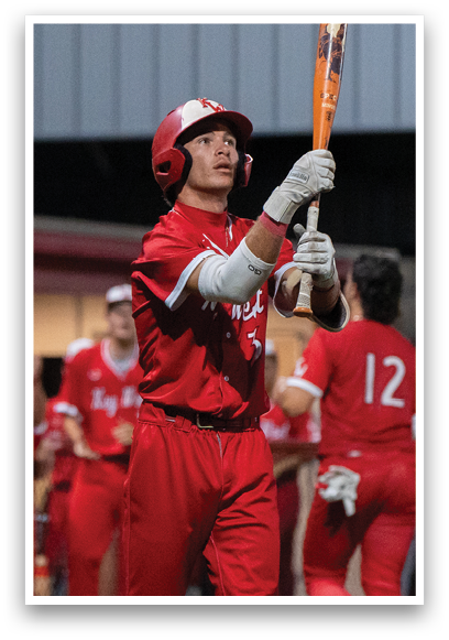 A baseball player holding a bat. Description generated by AI