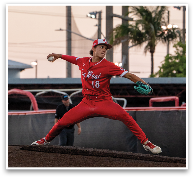 A baseball player in a red jersey is throwing a ball. Description generated by AI