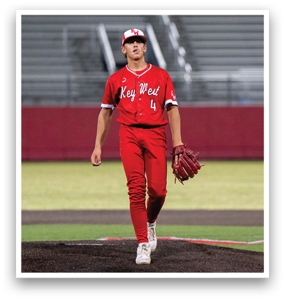 A baseball player wearing a red jersey and red pants. Description generated by AI