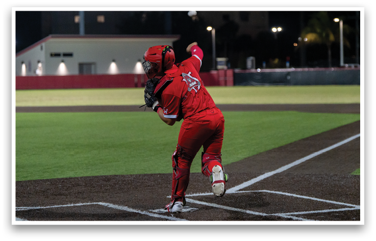 A baseball player in a red uniform is throwing a ball. Description generated by AI