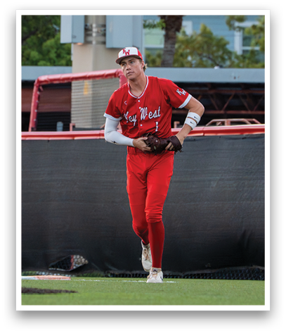 A baseball player wearing a red jersey and white socks. Description generated by AI