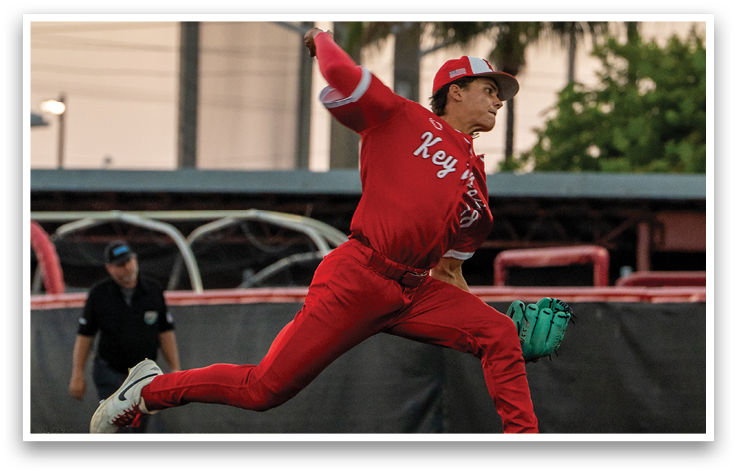 A baseball player in a red jersey is throwing a ball. Description generated by AI