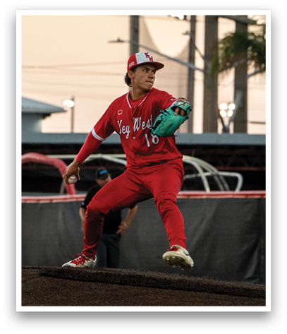 A baseball player in a red uniform is pitching a ball. Description generated by AI