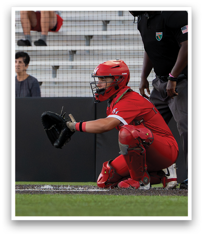A baseball player wearing a red shirt and red pants. Description generated by AI