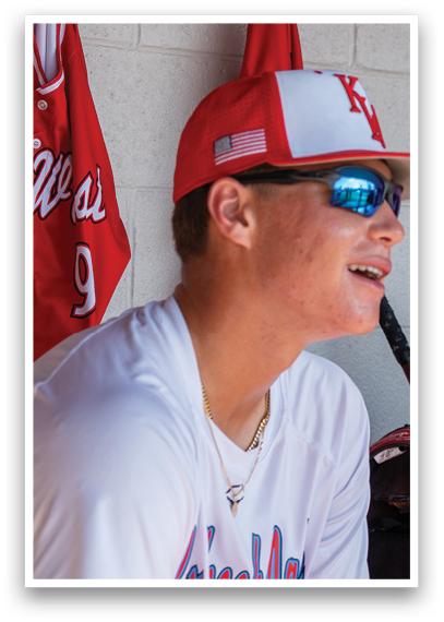 A man wearing a red and white hat and sunglasses. Description generated by AI