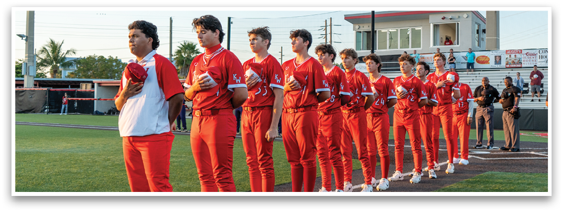 A group of young men wearing red shirts and red pants. Description generated by AI