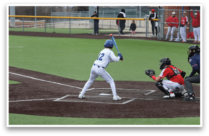 A baseball player is at bat, holding a bat and preparing to swing. AI generated content