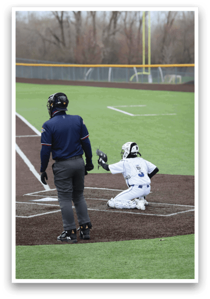 A baseball player is kneeling on the ground with his hands on his head. AI generated content