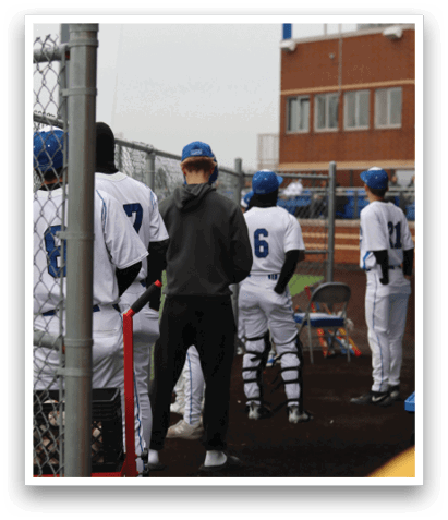 A group of baseball players in uniforms are standing next to a fence. AI generated content