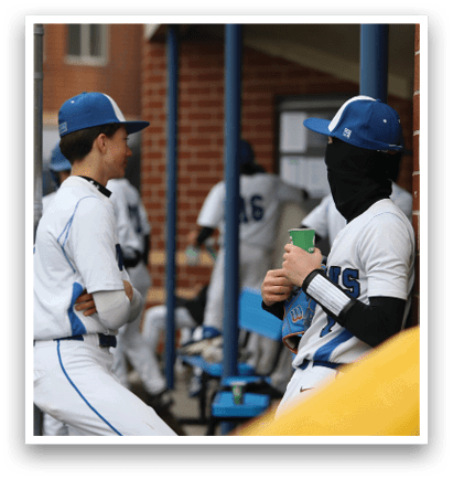 Two baseball players are standing next to a brick wall. One of them is wearing a mask. AI generated content