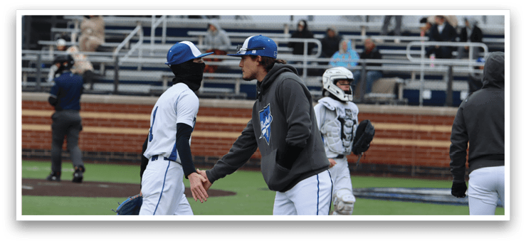 Baseball players on a field, some of them wearing blue and white uniforms, talking to each other. AI generated content