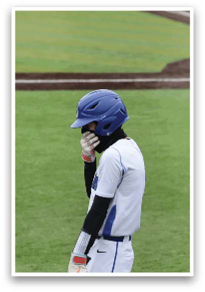 A baseball player wearing a blue helmet and white uniform is standing on a field. AI generated content