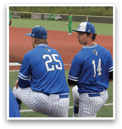 Two baseball players wearing blue uniforms are sitting on the ground. AI generated content