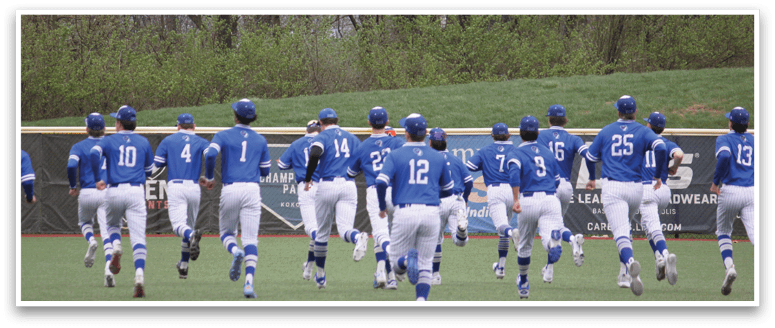 A group of baseball players wearing blue uniforms are walking on a field. AI generated content
