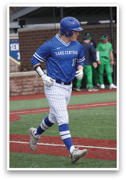 A baseball player in a blue shirt and white pants is running to first base. AI generated content